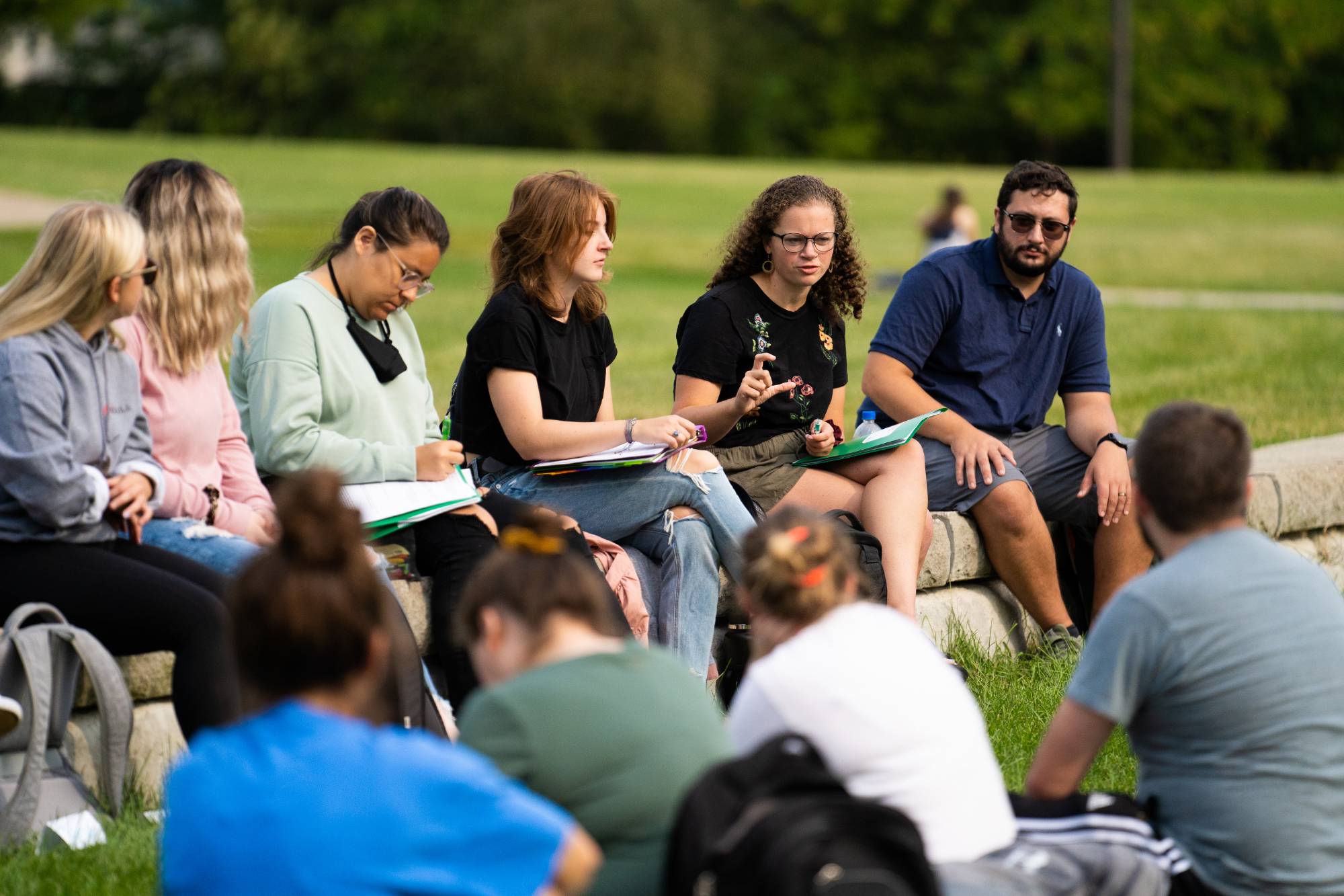 Group of students sitting outside during class